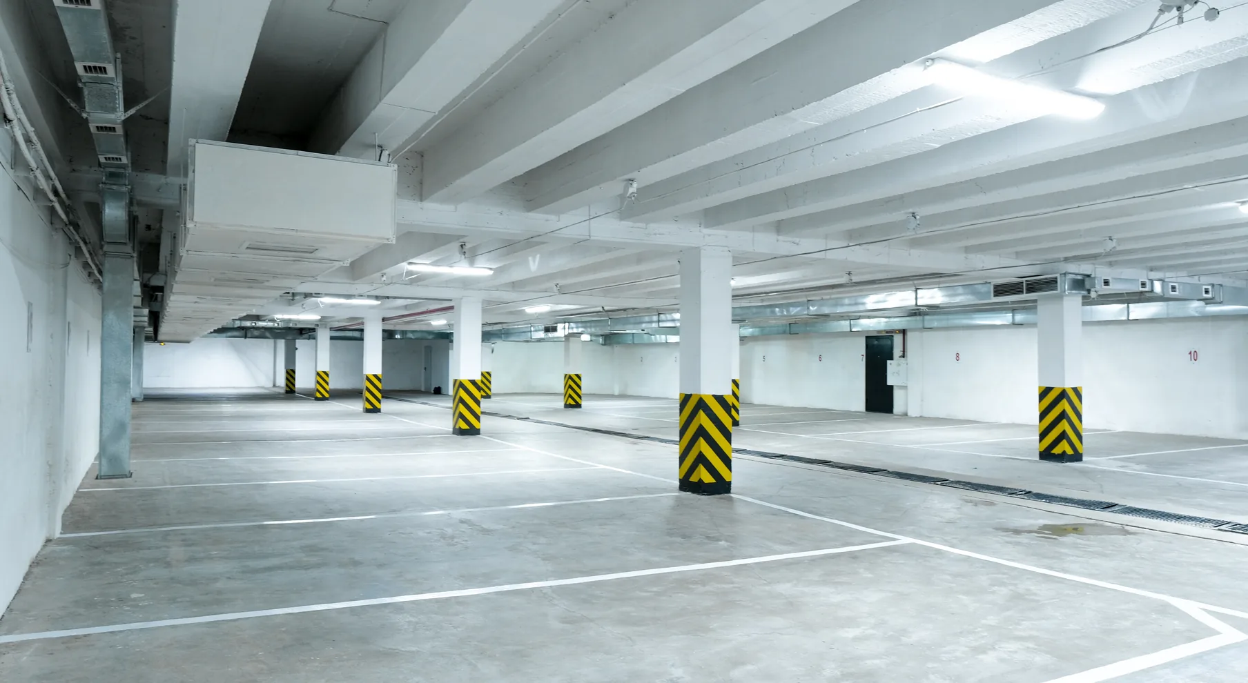 Open-plan car park interior with concrete columns