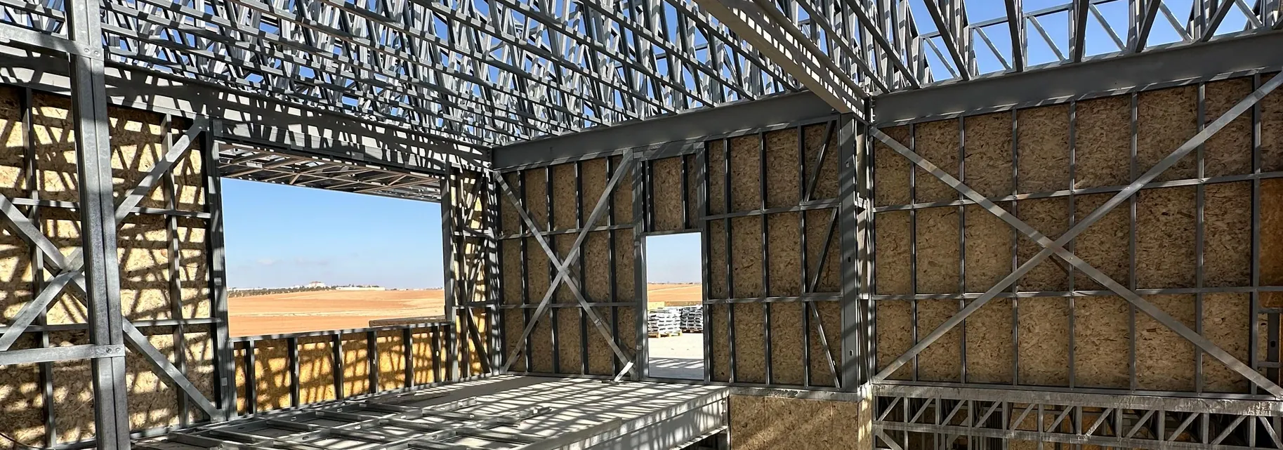 Light gauge steel wall panels and roof trusses under a clear sky on a Build With Steel project