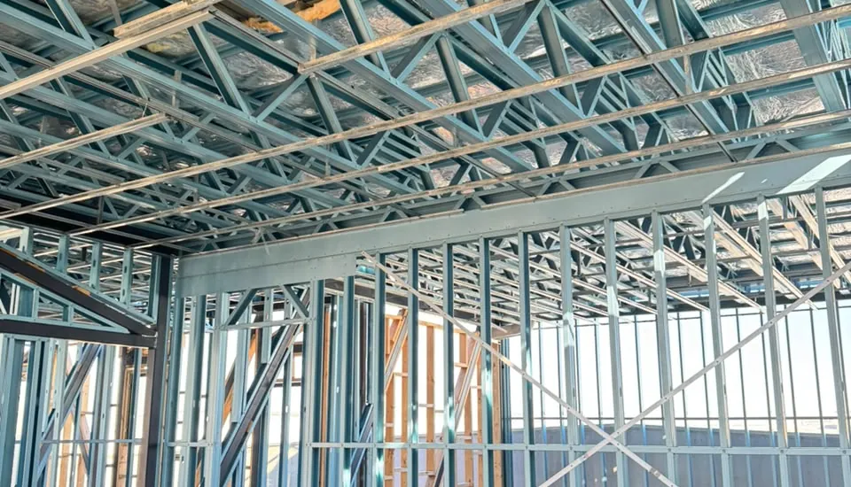 Inside a light gauge steel framed building with insulated floor cassettes overhead
