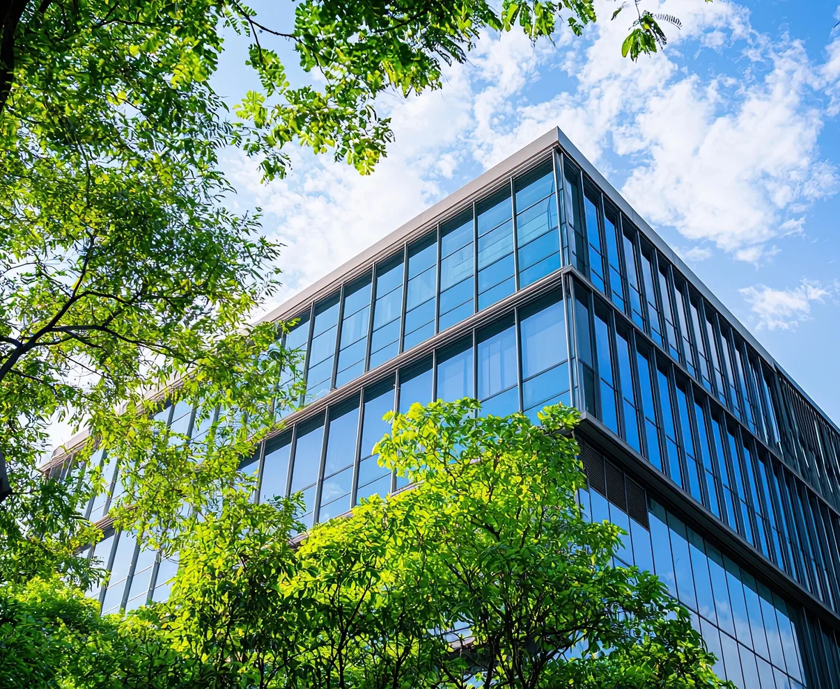 Glass-fronted building seen through trees