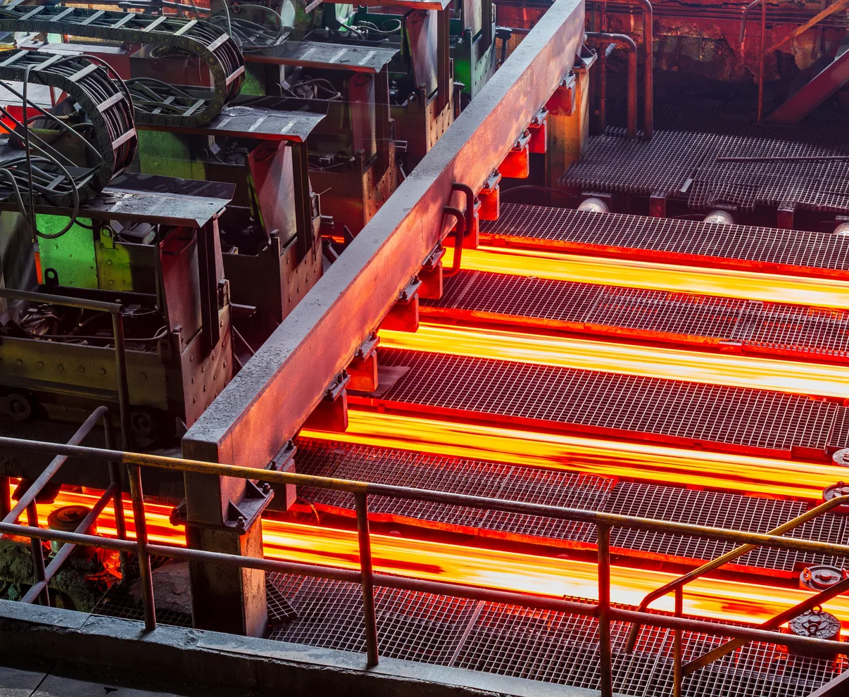 Red-hot steel strip passing through a rolling mill