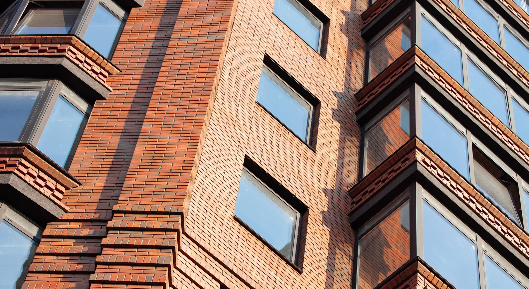 Brick masonry facade with bay windows